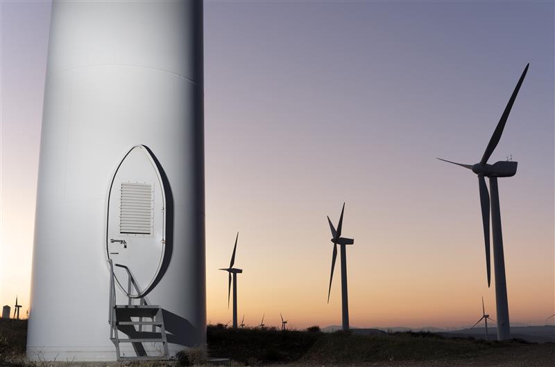 Solar energy companies require a flexible fleet solutions for maintenance of windmill network - an image of windmills in the sunset